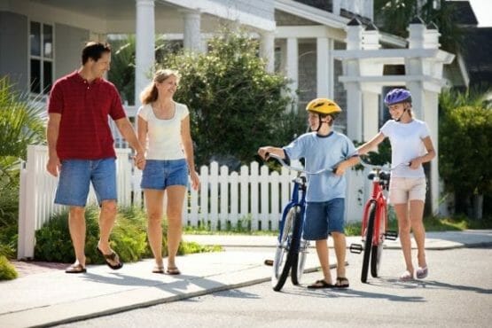 Family Walking With Bicycles