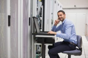 man looking up from working with servers