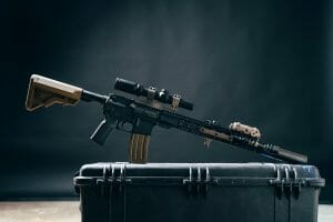 a riffle at the top of a black gun safe box