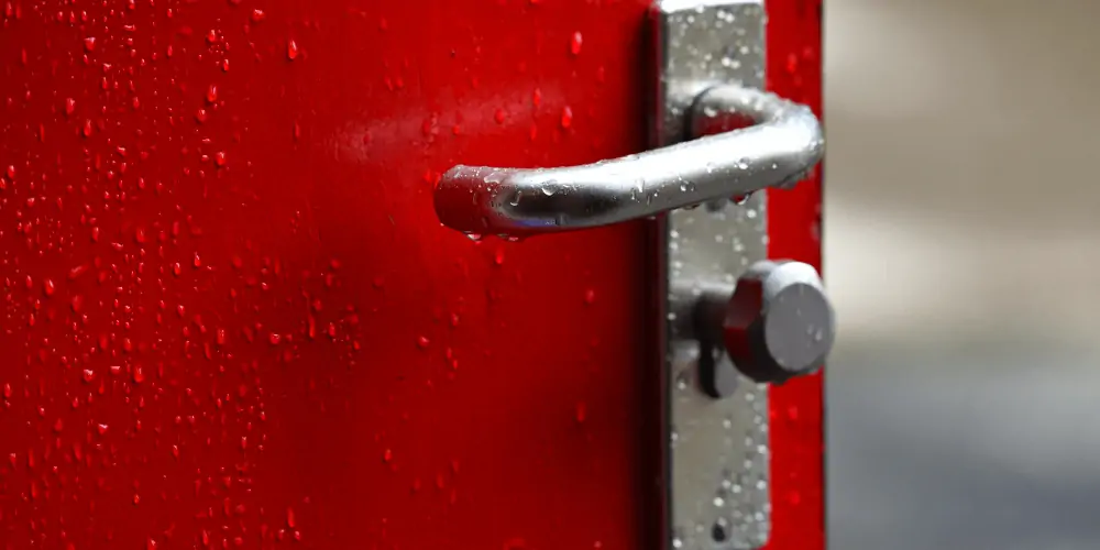 red aluminum door with raindrops