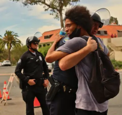 cops and a man hugging
