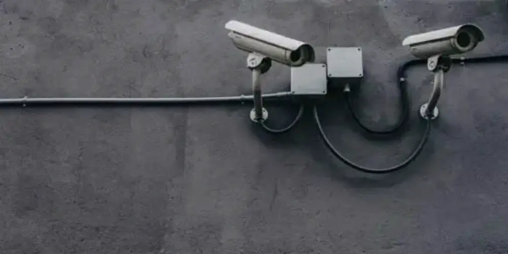 two wired cctv mounted on the wall