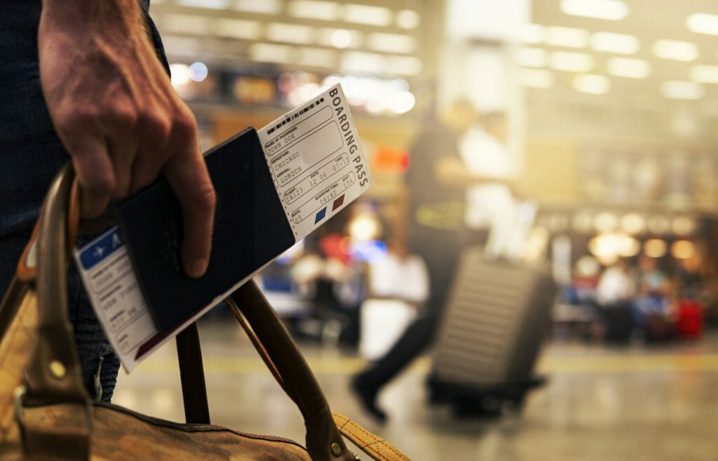 a man holding a boarding pass at the airport
