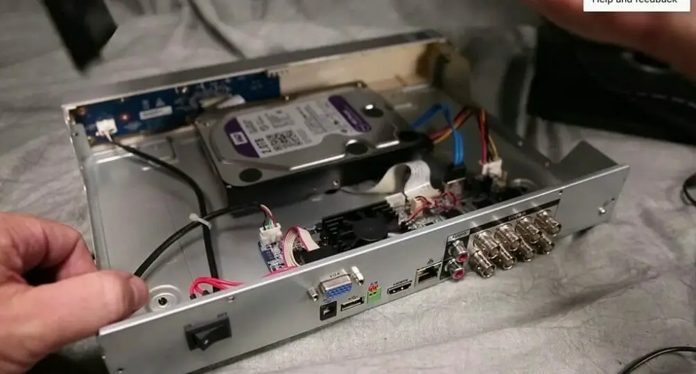 man's hand removing SATA HDD