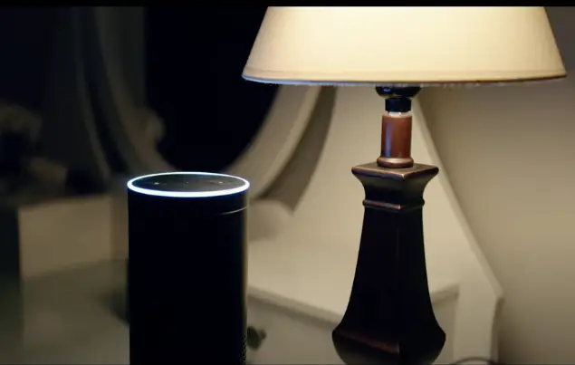 alexa device besides a night lamp