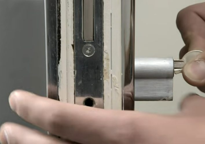 man inserting the key to a lock