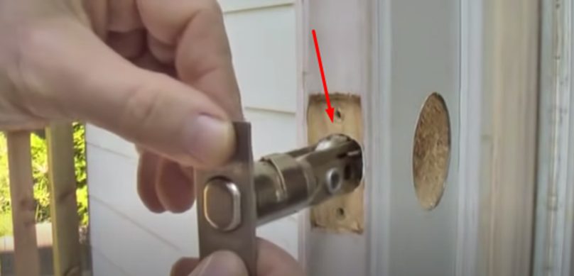 inserting the bolt into the hole
