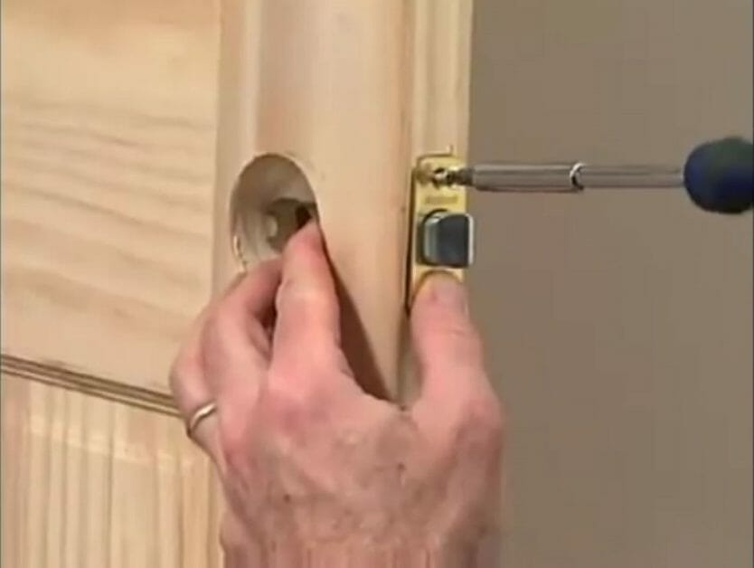 screwing the latch to the door