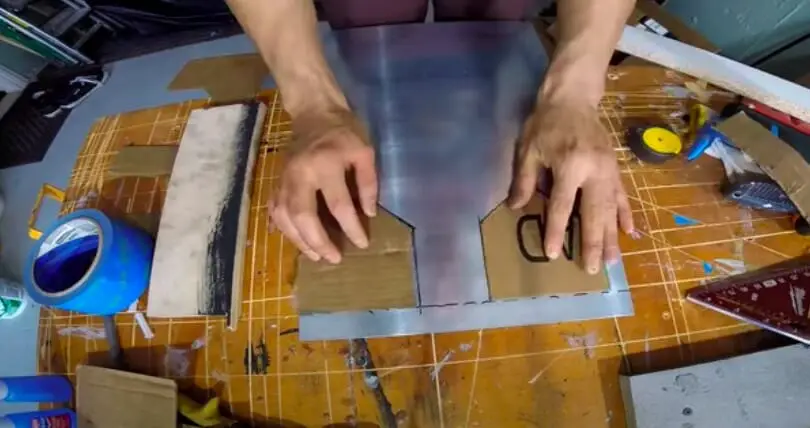 carving the shape into the metal sheet
