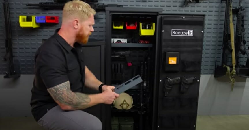 man beside above-ground gun safe