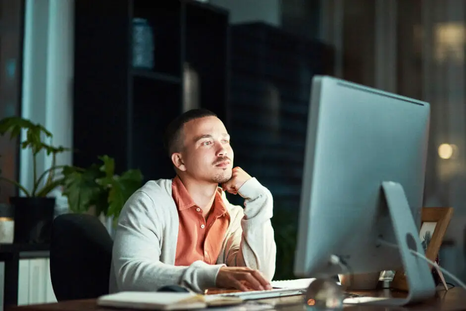 man working on his computer on a late night