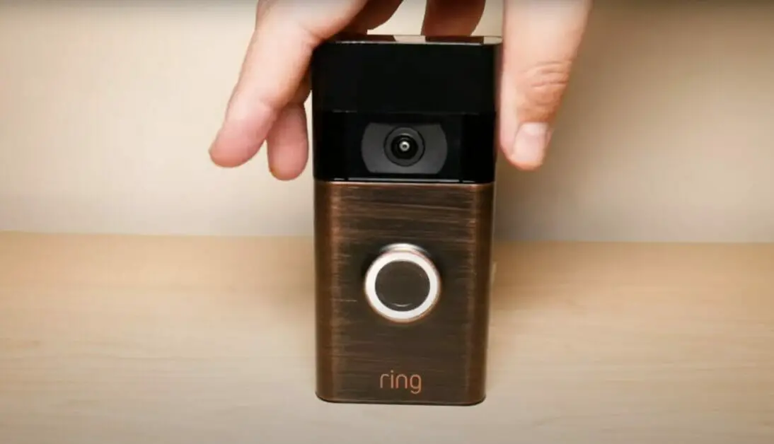 a hand holding a Ring video camera