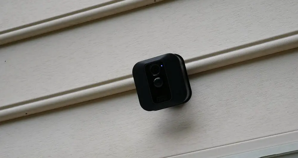Blink XT2 security camera in color black mounted at the outdoor wall