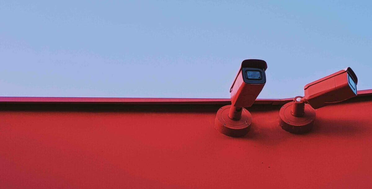 red cctv camera camouflaging the red wall