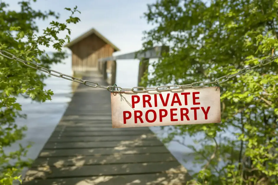 water shed area with private property sign attached to a chain