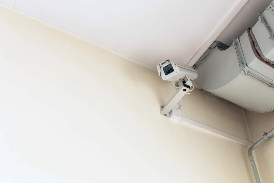 wired cctv camera at the top side of an indoor wall