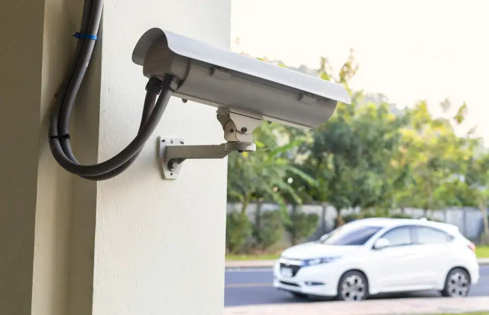 wired cctv installed at the building post pointing at the car park outside